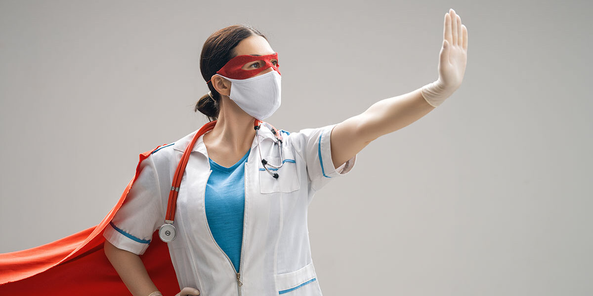 doctor-wearing-facemask-and-superhero-cape-24URE3J