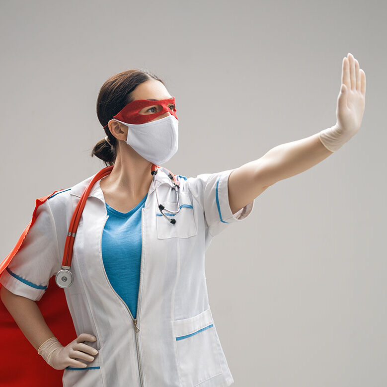 doctor-wearing-facemask-and-superhero-cape-24URE3J
